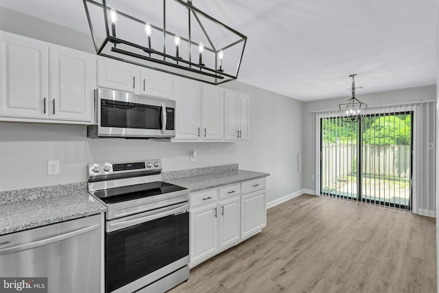 18721 Paprika Ct, Germantown, MD 20874 - kitchen with stainless steel appliances, a chandelier, white cabinetry, and light wood-type flooring