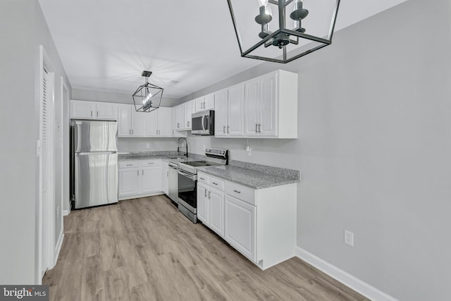 18721 Paprika Ct, Germantown, MD 20874 - kitchen with stainless steel appliances, a chandelier, white cabinets, light wood-style flooring, and light stone countertops
