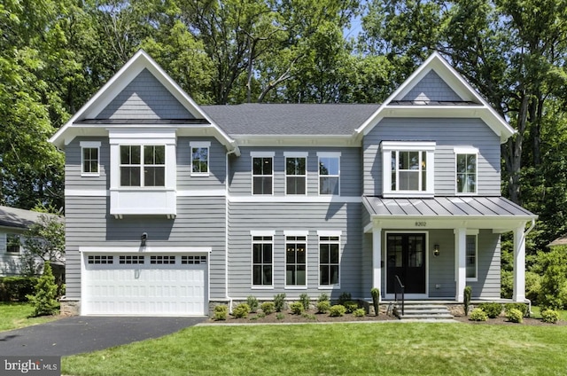 8202 Mockingbird Dr, Annandale, VA 22003 - view of front facade with a front yard, a standing seam roof, an attached garage, a porch, and asphalt driveway