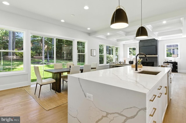 8202 Mockingbird Dr, Annandale, VA 22003 - kitchen featuring recessed lighting, light wood-style floors, a center island with sink, coffered ceiling, and beam ceiling