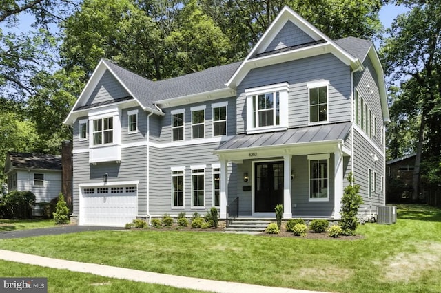 8202 Mockingbird Dr, Annandale, VA 22003 - view of front of house featuring a garage, a porch, asphalt driveway, a front yard, and a standing seam roof