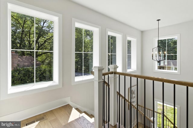 8202 Mockingbird Dr, Annandale, VA 22003 - hallway with an upstairs landing, a chandelier, and wood finished floors