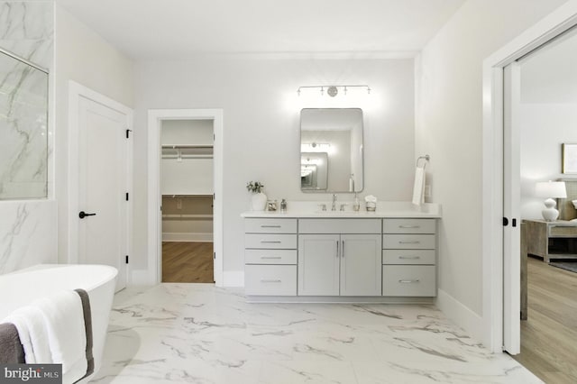8202 Mockingbird Dr, Annandale, VA 22003 - full bathroom featuring vanity, a soaking tub, a spacious closet, and marble finish floors