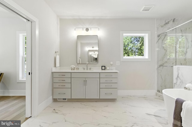 8202 Mockingbird Dr, Annandale, VA 22003 - bathroom with vanity, a marble finish shower, a freestanding tub, and marble finish floors