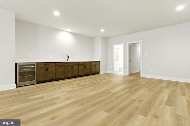 8202 Mockingbird Dr, Annandale, VA 22003 - indoor wet bar featuring wine cooler, light wood-style floors, and recessed lighting