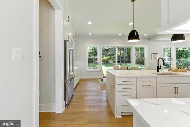 8202 Mockingbird Dr, Annandale, VA 22003 - kitchen featuring white cabinets, light wood-style floors, high end fridge, light stone counters, and recessed lighting