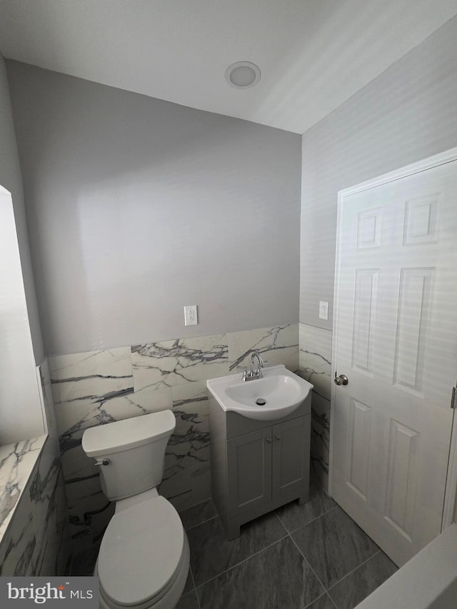 4735 Frankford Ave, Philadelphia, PA 19124 - bathroom featuring tile walls, vanity, and a wainscoted wall