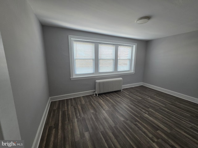 4735 Frankford Ave, Philadelphia, PA 19124 - spare room with radiator heating unit and dark wood-style floors