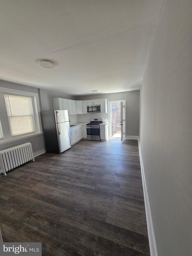 4735 Frankford Ave, Philadelphia, PA 19124 - unfurnished living room featuring radiator and dark wood-style flooring