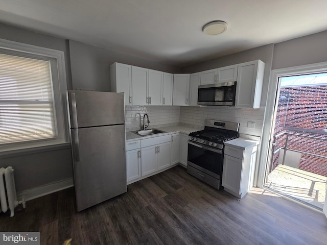4735 Frankford Ave, Philadelphia, PA 19124 - kitchen with appliances with stainless steel finishes, radiator, light countertops, and healthy amount of natural light
