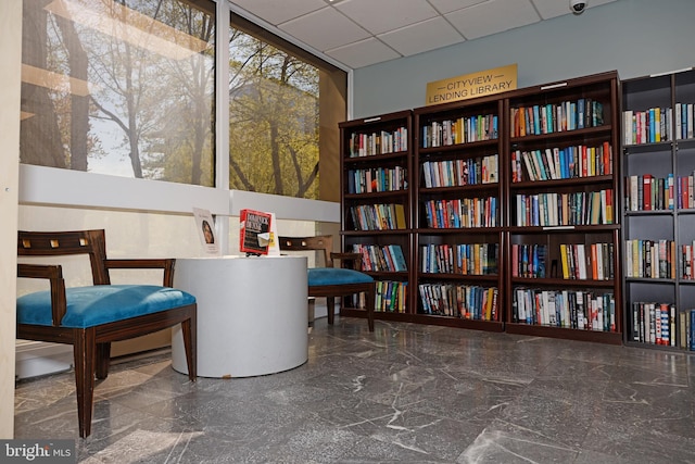 2001 Hamilton St Unit 1205, Philadelphia, PA 19130 - sitting room featuring wall of books and marble tiled flooring