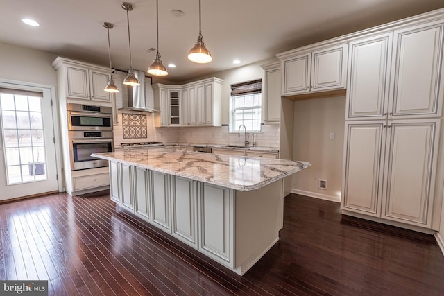 4251 Beech Dr, Nazareth, PA 18064 - kitchen with wall chimney range hood, appliances with stainless steel finishes, dark wood-style flooring, a center island, and recessed lighting