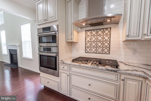 4251 Beech Dr, Nazareth, PA 18064 - kitchen featuring wall chimney range hood, stainless steel appliances, dark wood-type flooring, and decorative backsplash