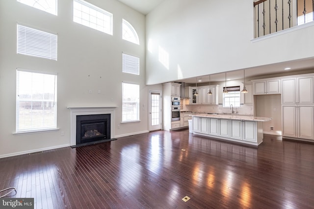 4251 Beech Dr, Nazareth, PA 18064 - unfurnished living room with a high ceiling, dark wood finished floors, and a glass covered fireplace