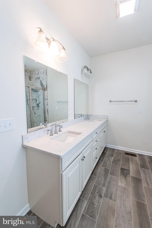 4251 Beech Dr, Nazareth, PA 18064 - bathroom with double vanity, a shower stall, and wood tiled floors