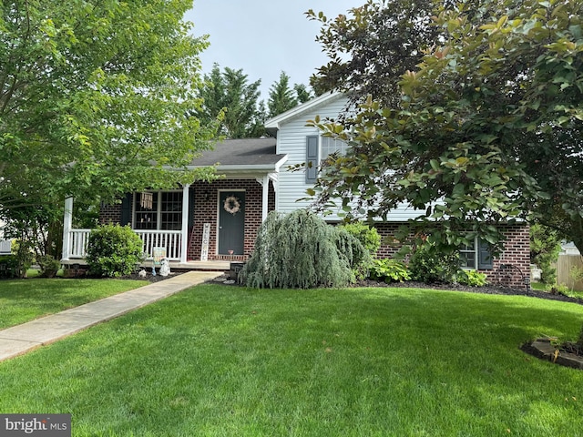 408 Lexington Way, Littlestown, PA 17340 - view of front facade featuring brick siding, a front yard, and covered porch