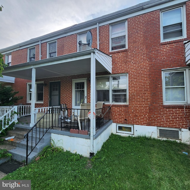 3648 Benson Ave, Baltimore, MD 21227 - townhome / multi-family property featuring brick siding, a front yard, and covered porch