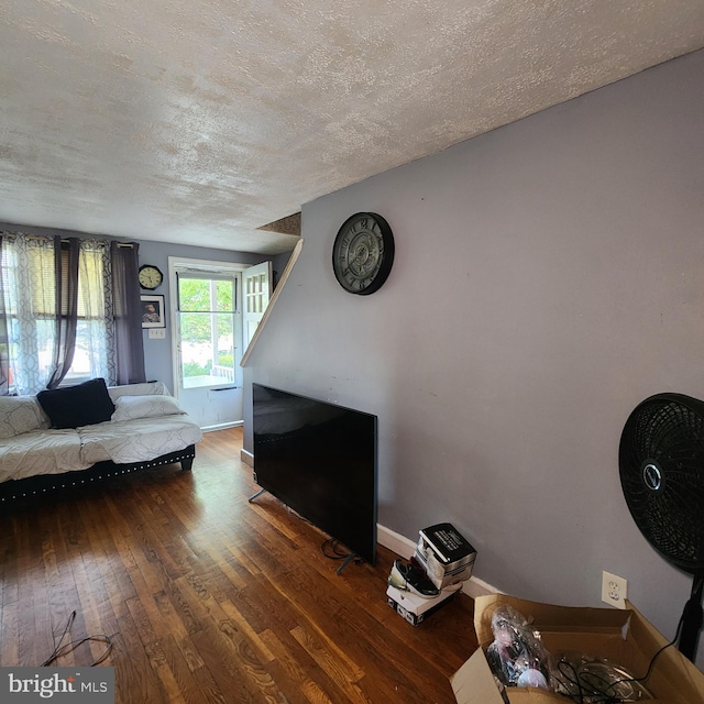 3648 Benson Ave, Baltimore, MD 21227 - living room featuring wood-type flooring and a textured ceiling