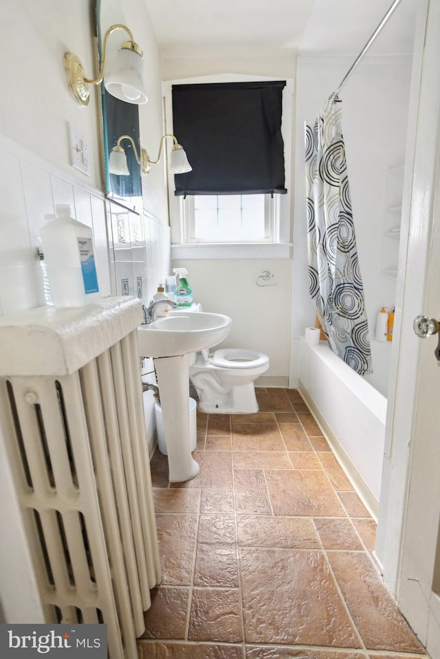 1711 W Union Blvd, Bethlehem, PA 18018 - full bathroom with radiator heating unit, stone tile floors, and shower / bathtub combination with curtain