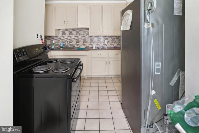 1711 W Union Blvd, Bethlehem, PA 18018 - kitchen with electric range, freestanding refrigerator, decorative backsplash, light tile patterned flooring, and white cabinets