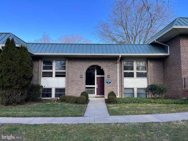 3445 S Leisure World Blvd Unit 87-2C, Silver Spring, MD 20906 - view of front of home featuring a standing seam roof, a metal roof, a front yard, and brick siding
