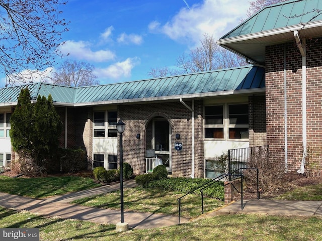 3445 S Leisure World Blvd Unit 87-2C, Silver Spring, MD 20906 - view of front facade featuring a standing seam roof, brick siding, and a metal roof