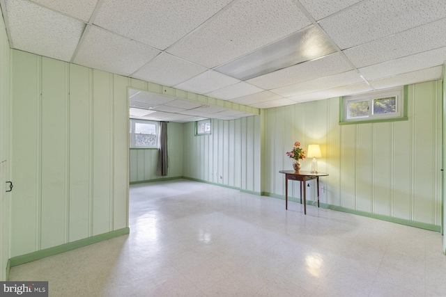 12703 Bluhill Rd, Silver Spring, MD 20906 - basement featuring a paneled ceiling, a decorative wall, and tile patterned floors