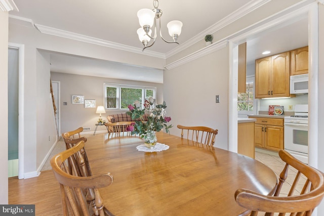 12703 Bluhill Rd, Silver Spring, MD 20906 - dining space featuring a chandelier, crown molding, and light wood-style floors