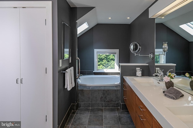 697 Prospect Ave, Princeton, NJ 08540 - full bath featuring lofted ceiling, a garden tub, double vanity, tile patterned floors, and a skylight