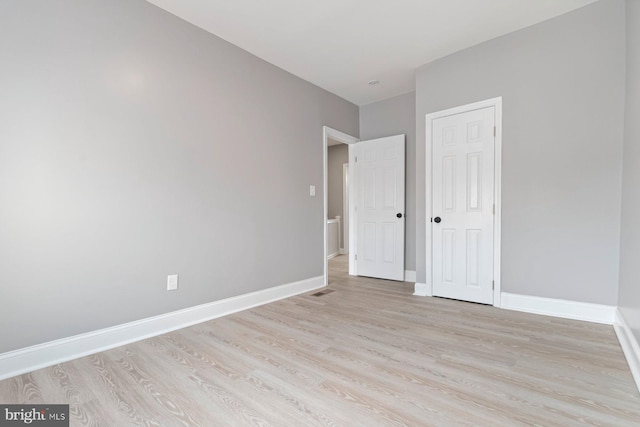 1539 N Payson St, Baltimore, MD 21217 - unfurnished bedroom featuring light wood-style flooring and a closet