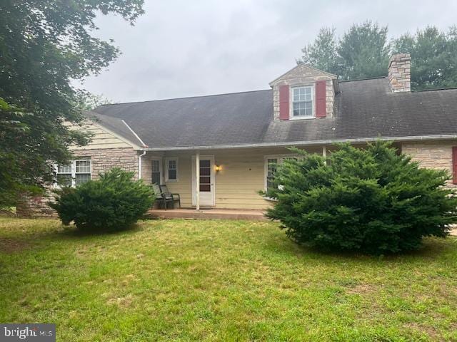 60 Buckwalter Rd, Royersford, PA 19468 - new england style home featuring a front yard, a porch, a chimney, and stone siding