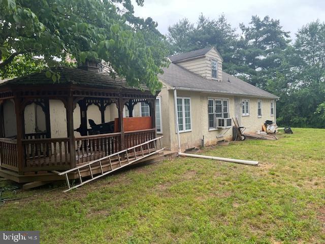60 Buckwalter Rd, Royersford, PA 19468 - back of house featuring a gazebo, a yard, stucco siding, a wooden deck, and cooling unit