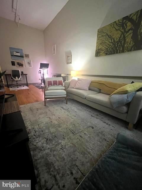 511 S Bond St Unit 304, Baltimore, MD 21231 - living area with wood finished floors, a desk, and high vaulted ceiling