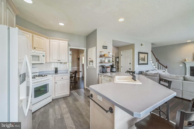 1012 Woodridge Rd, Red Lion, PA 17356 - kitchen with white appliances, a breakfast bar area, open floor plan, recessed lighting, and wood finished floors