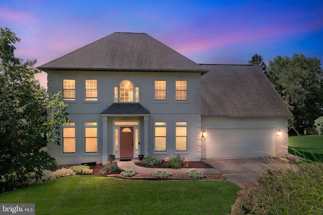 1012 Woodridge Rd, Red Lion, PA 17356 - view of front of property featuring a shingled roof, an attached garage, driveway, a lawn, and stucco siding