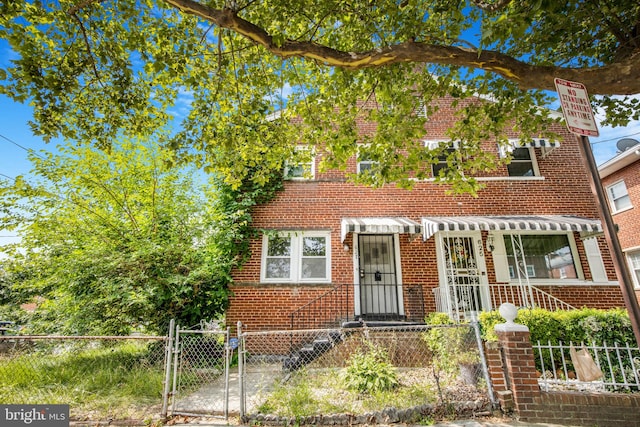 627 Forrester St SE, Washington, DC 20032 - view of front of house with a fenced front yard, a gate, and brick siding