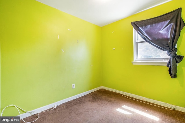 627 Forrester St SE, Washington, DC 20032 - unfurnished room with baseboards and dark colored carpet