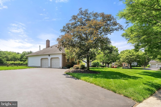 28 Amherst Way, West Windsor, NJ 08550 - view of front of house with asphalt driveway, an attached garage, brick siding, and a chimney
