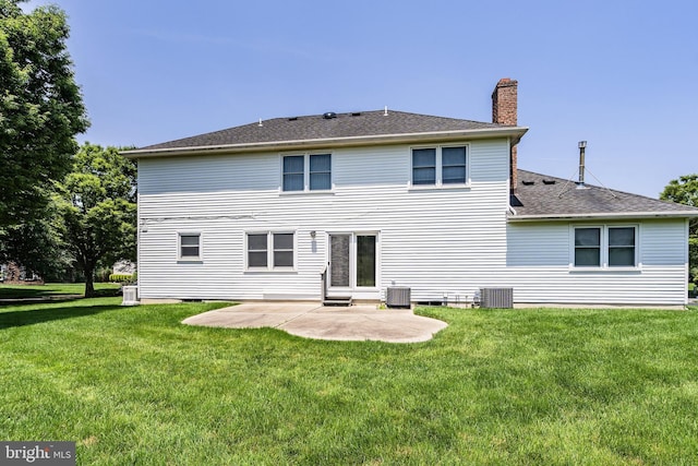 28 Amherst Way, West Windsor, NJ 08550 - rear view of house featuring a chimney, a patio, a lawn, and a shingled roof