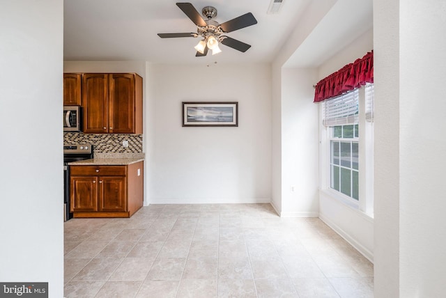 12 Juniper Ct Unit 63, Millville, DE 19967 - kitchen featuring appliances with stainless steel finishes, decorative backsplash, a ceiling fan, and light tile patterned floors
