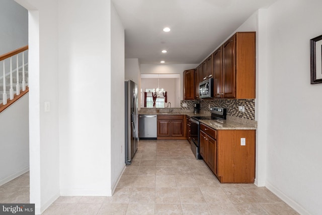 12 Juniper Ct Unit 63, Millville, DE 19967 - kitchen featuring stainless steel appliances, light stone counters, a chandelier, backsplash, and recessed lighting