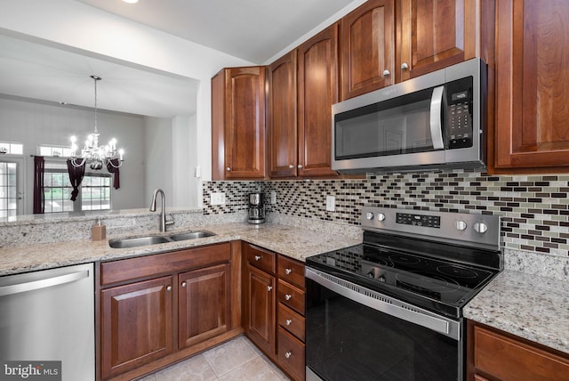 12 Juniper Ct Unit 63, Millville, DE 19967 - kitchen with stainless steel appliances, a chandelier, tasteful backsplash, and light stone counters