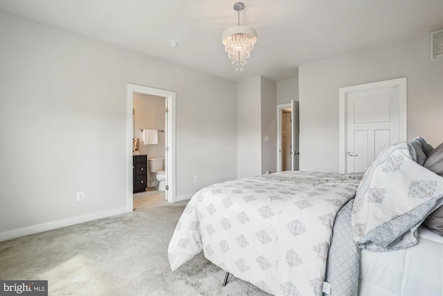 18004 Red Cedar Rd, Dumfries, VA 22026 - bedroom with light carpet, a chandelier, and ensuite bath