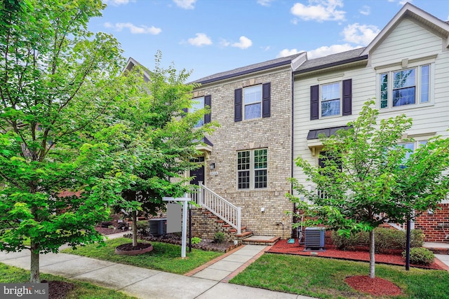 18004 Red Cedar Rd, Dumfries, VA 22026 - view of property with brick siding and a front lawn