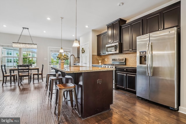 18004 Red Cedar Rd, Dumfries, VA 22026 - kitchen featuring stainless steel appliances, dark wood-style flooring, light stone countertops, tasteful backsplash, and recessed lighting