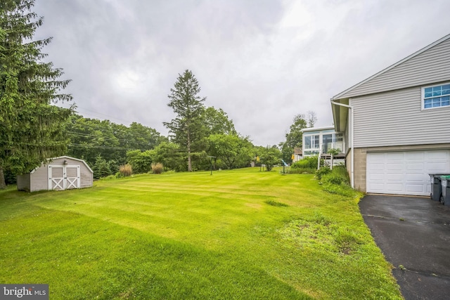 23 Maple St, Ashland, PA 17921 - view of green lawn with a storage unit, driveway, and a garage