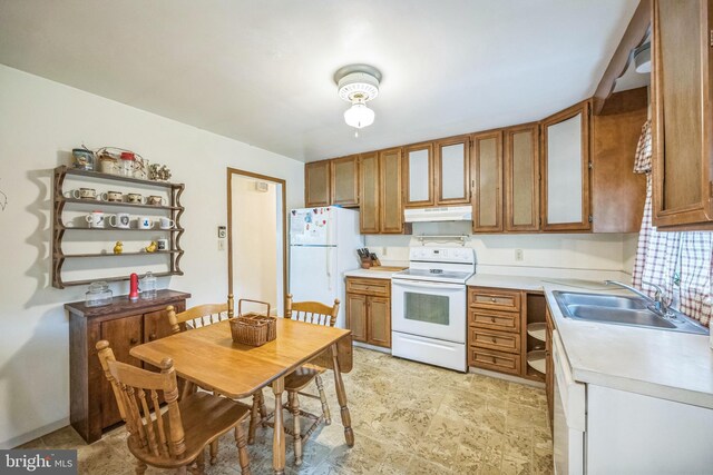 23 Maple St, Ashland, PA 17921 - kitchen with white appliances, under cabinet range hood, light countertops, and brown cabinets