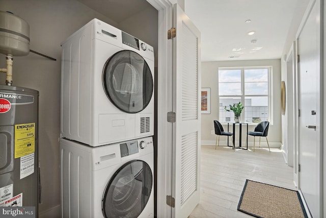 901 19th St NE Unit Ph2, Washington, DC 20002 - laundry room featuring water heater, stacked washer / drying machine, light wood finished floors, and recessed lighting