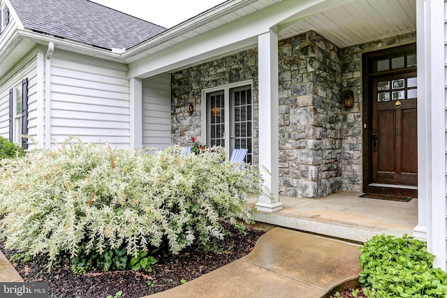 10 Elser Hill Rd, Lititz, PA 17543 - view of exterior entry with stone siding, covered porch, and roof with shingles
