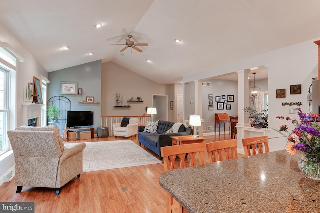 10 Elser Hill Rd, Lititz, PA 17543 - living room featuring light wood finished floors, vaulted ceiling, ornate columns, a ceiling fan, and a fireplace